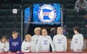 New Ulm boy’s hockey players look out at the ice before taking on Warroad in a Class A boy’s hockey quarterfinal game at Xcel Energy Arena.