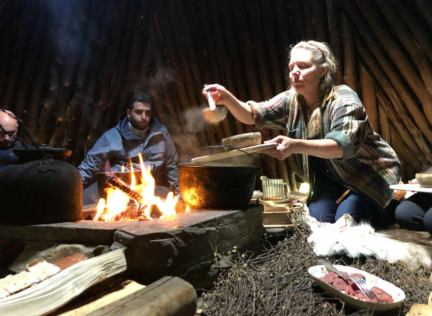 Anki Vinka serves lunch inside a traditional Sami tepee-like structure called a goathie. (Mark Johanson/Chicago Tribune/TNS) ORG XMIT: 1474867