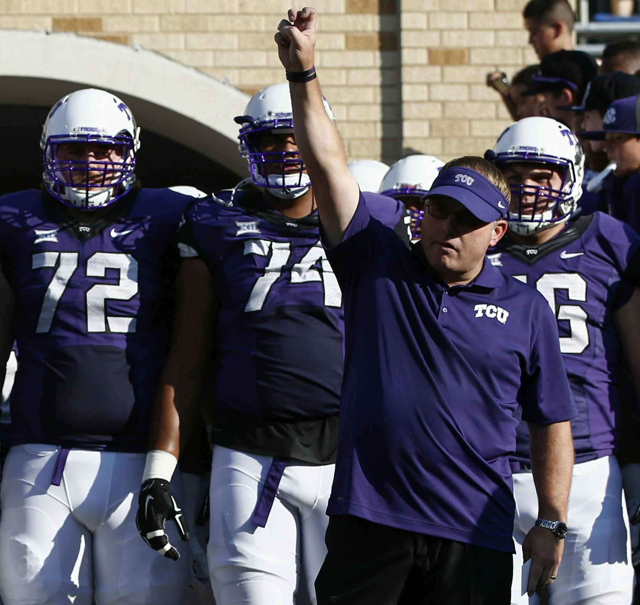 TCU head coach Gary Patterson salutes the crowd as he prepares to lead his team onto the field against Samford before an NCAA college football game in Fort Worth, Texas, Saturday, Aug. 30, 2014. (AP Photo/Jim Cowsert) ORG XMIT: TXJC1xx