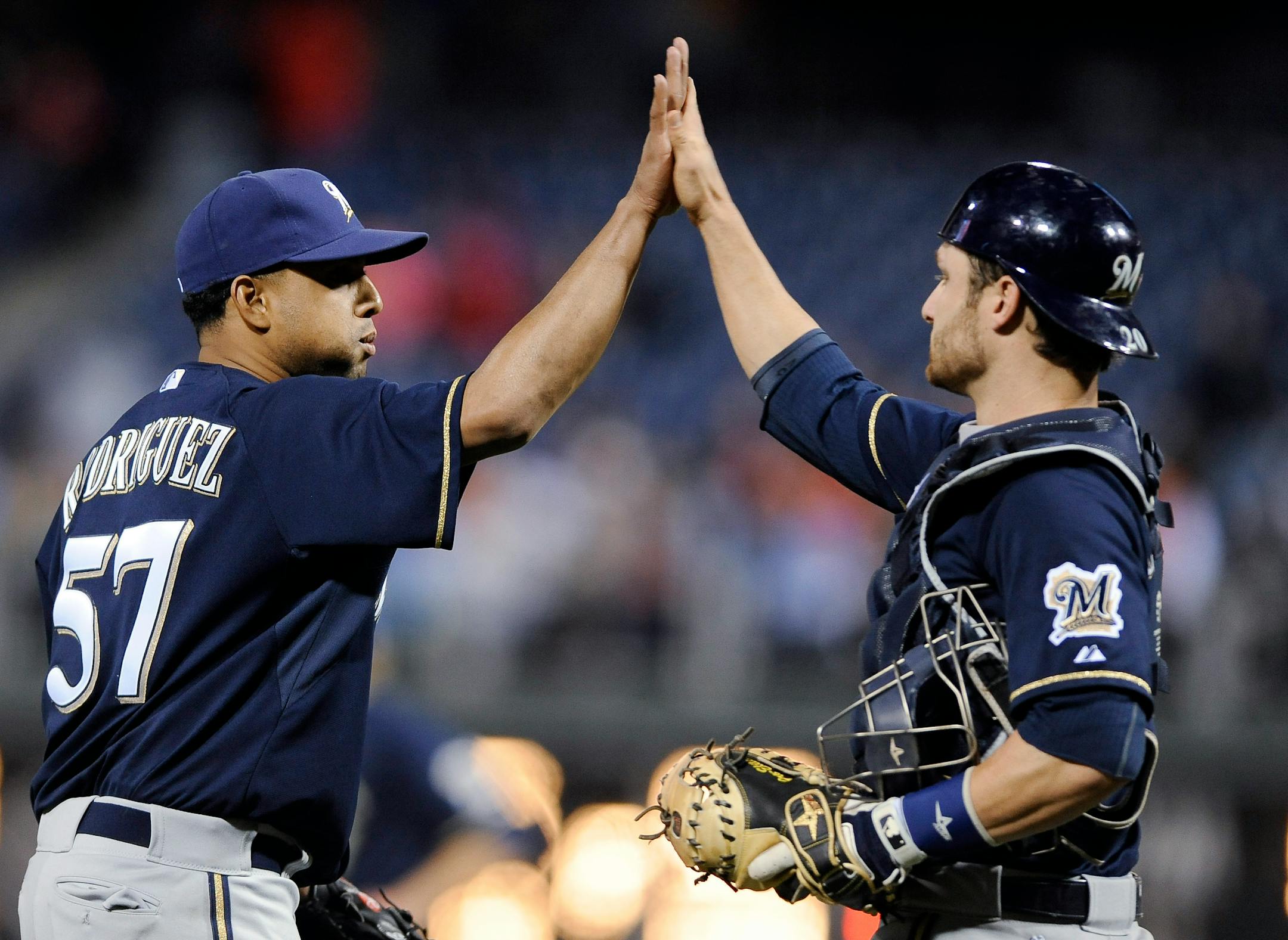 Milwaukee Brewers' Francisco Rodriguez (57) celebrates with Jonathan Lucroy at the end of a baseball game against the Philadelphia Phillies on Thursday, April 10, 2014, in Philadelphia. The Brewers won 6-2. (AP Photo/Michael Perez)