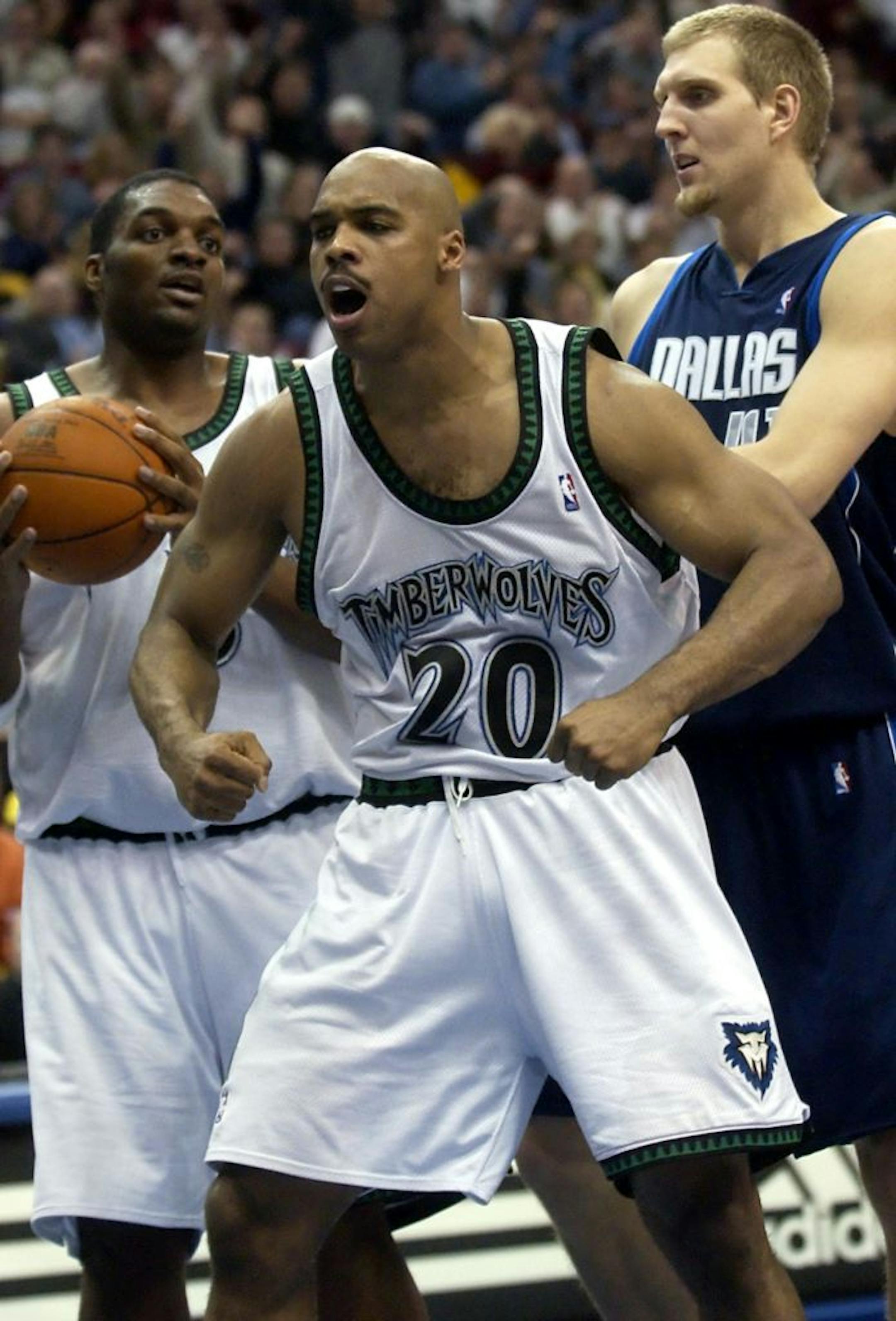 Minnesota Timberwolves forward Gary Trent (20) reacts as a foul is called on Dallas Mavericks' Antawn Jamison while Timberwolves center Oliver Miller, left, and Mavericks forward Dirk Nowitzki, right, watch during the fourth quarter in Minneapolis, Thursday, Dec. 18, 2003. Trent's game isn't agility and grace, it's power and aggression.