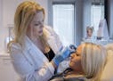 Daisha DeMike of St. Paul held got a Botox treatment from injection specialist Rebecca Suess Thursday. ] ANTHONY SOUFFLE &#x2022; anthony.souffle@star