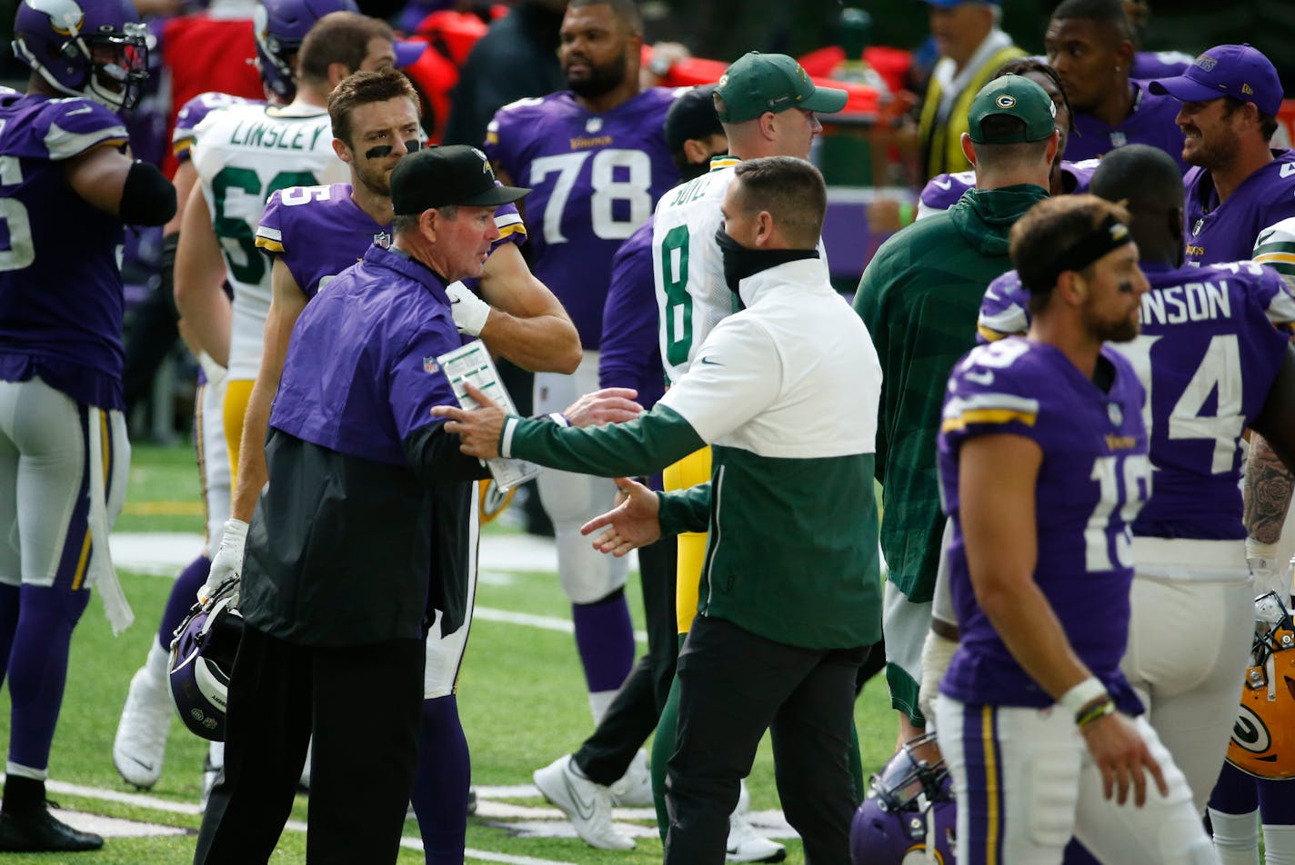 Minnesota Vikings head coach Mike Zimmer, left, greets Green Bay Packers head coach Matt LaFleur after an NFL football game, Sunday, Sept. 13, 2020, in Minneapolis. The Packers won 43-34. (AP Photo/Bruce Kluckhohn)