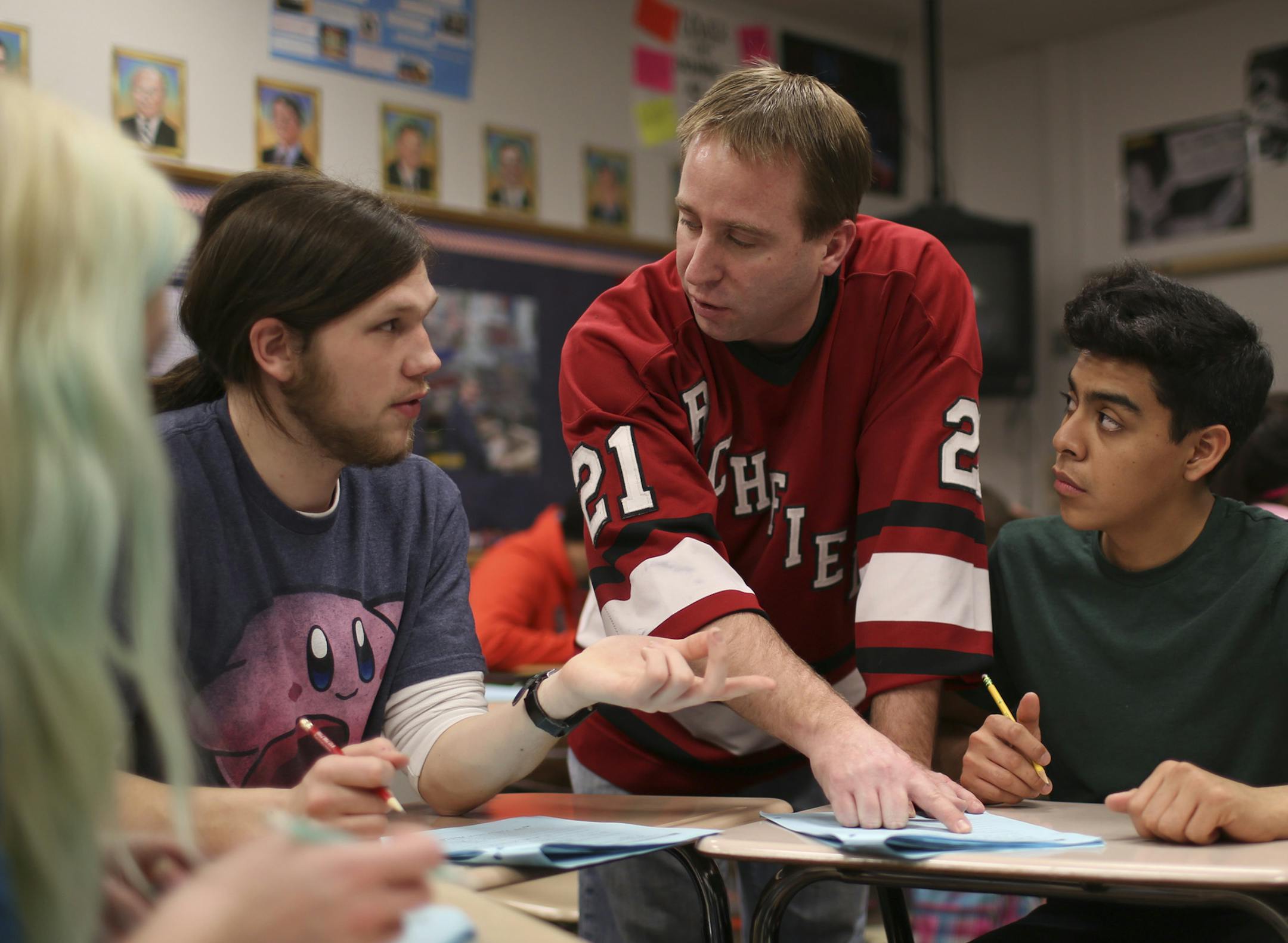 The state Department of Educatio released data Wednesdaty that showed graduation rates are the highest they've been in a decade. Richfield High School is among those with a very good gain. Teacher Mike Harris, center, checked in with Arly Anderson, Mathias Habegger, Pedro Lagunas, and Sam Spratt, from left, as they discussed absolute and comparative values in his college prep Econ class Wednesday afternoon February 19, 2014. ] JEFF WHEELER ‚Ä¢ jeff.wheeler@startribune.com
