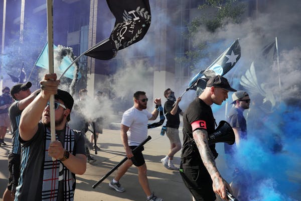 Minnesota United fans carrying smoke bombs paraded into TCF Bank Stadium prior Saturday's match between the Minnesota United and the Montreal Impact.