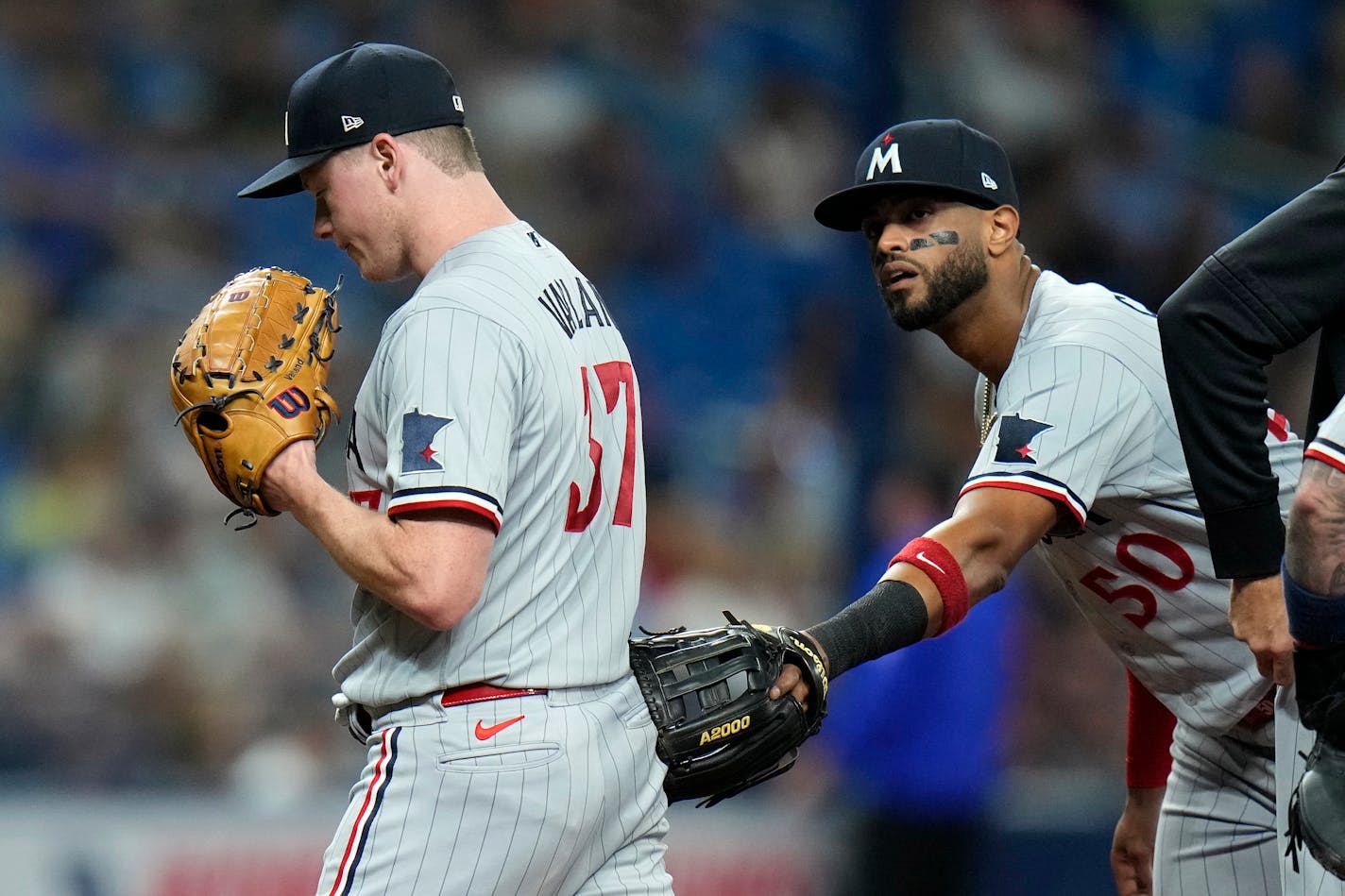 Minnesota Twins starting pitcher Louie Varland (37) reacts with left fielder Willi Castro (50) after being taken out of the game against the Tampa Bay Rays during the seventh inning of a baseball game Tuesday, June 6, 2023, in St. Petersburg, Fla. (AP Photo/Chris O'Meara)