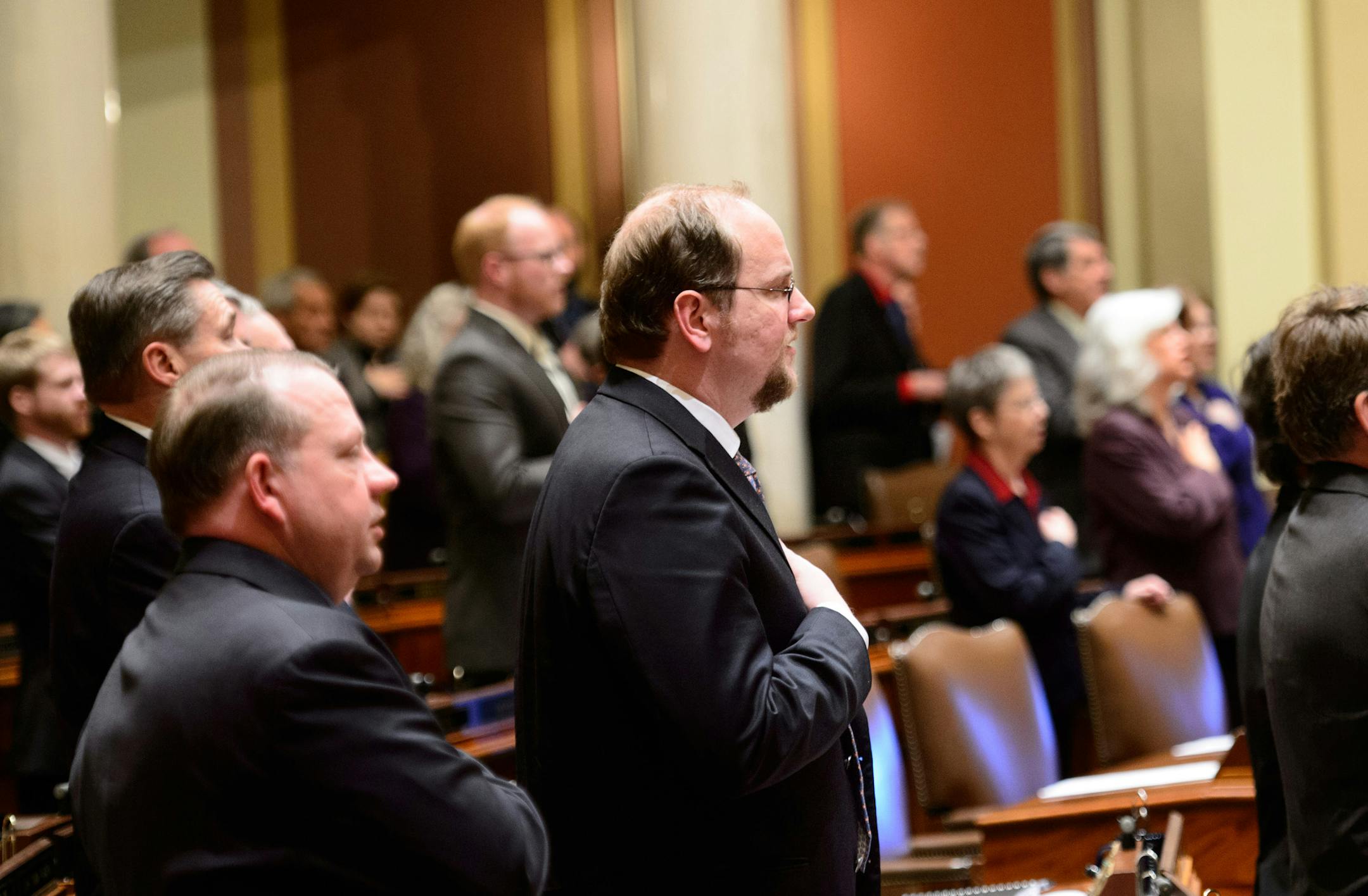 State Rep. David FitzSimmons, center, R-Albertville stands for the Pledge of Allegiance to ope the 2014 legislative session Tuesday, Feb, 25, 2014, in St. Paul, Minn. Over the weekend he lost an party endorsement vote due to his support for same-sex marriage. (AP Photo/The Star Tribune, Glen Stubbe) MANDATORY CREDIT; ST. PAUL PIONEER PRESS OUT; MAGS OUT; TWIN CITIES TV OUT