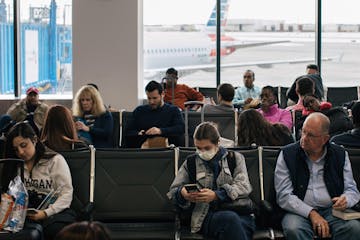 A traveler wears a face mask at an airport near Detroit, Feb. 27, 2020.