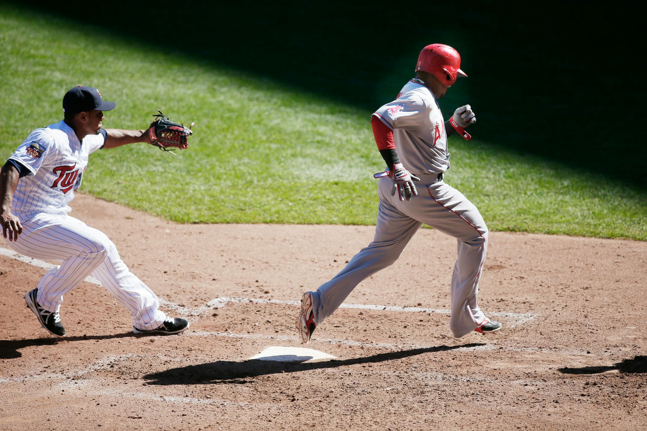 The Angels' Erick Aybar scored on a wild pitch by Twins relief pitcher Lester Oliveros, who arrived too late to cover the plate in Los Angeles' 14-4 rout at Target Field on Sunday.