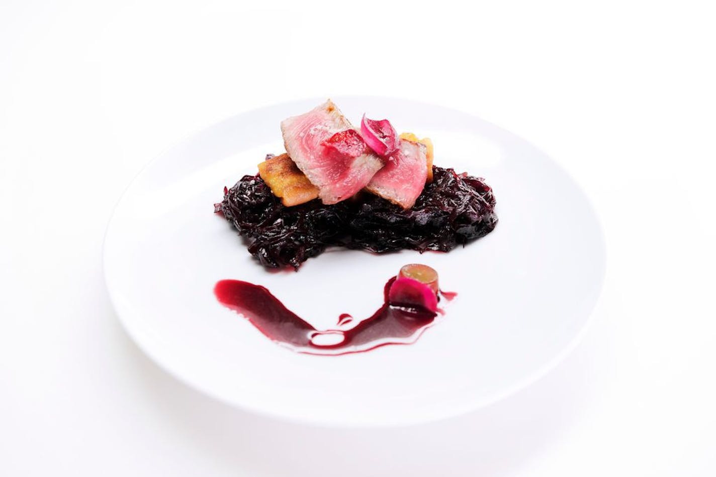 Justin Sutherland's 'Purple Rain' dish on 'Top Chef' consists of New York Strip with braised red cabbage, beet potato dumpling and purple pearl onion.