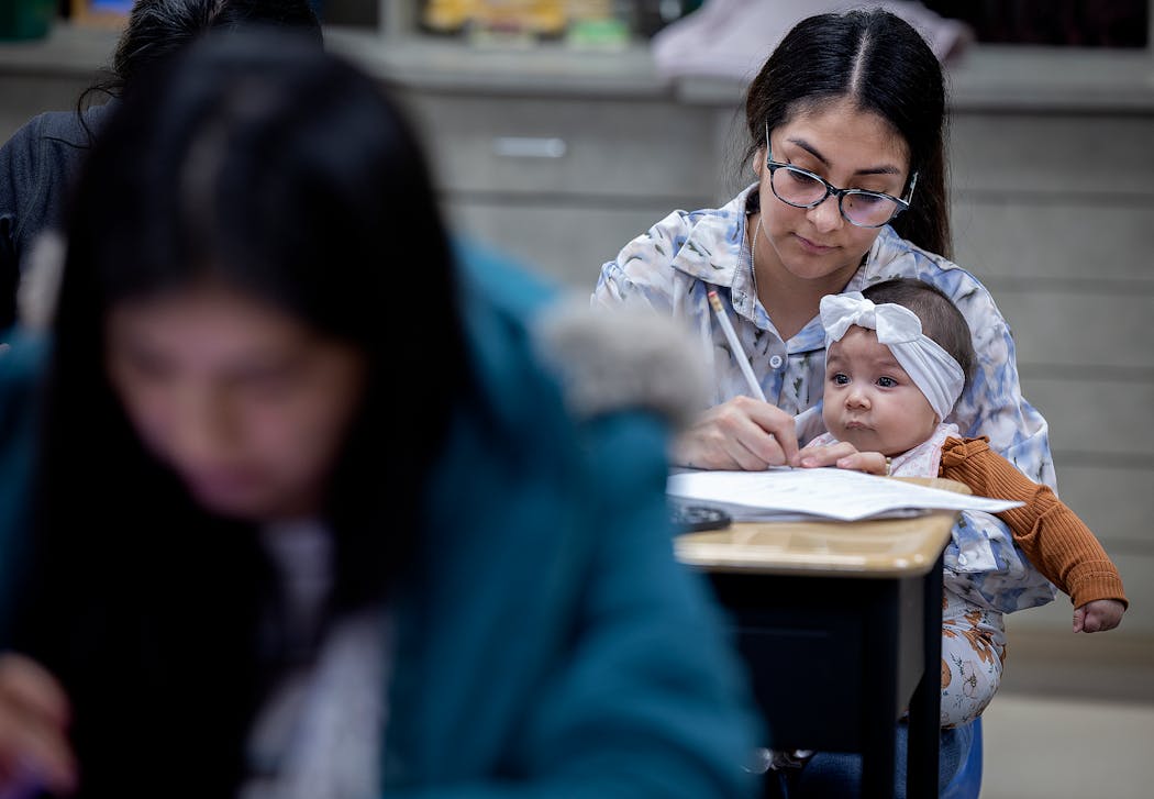 Pilar, who used to work at the Hylife Pork Processing Plant in the Quality area, held her baby as she took an adult literacy class at the Windom High School in Windom on Jan. 23.