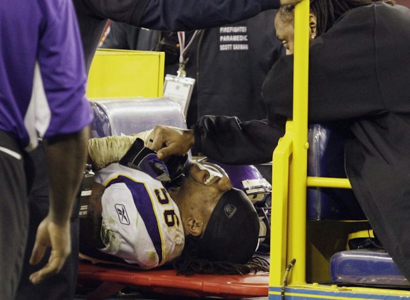 Vikings middle linebacker E.J. Henderson is comforted by a teammate as he is carted off the field after breaking his left femur in the fourth quarter of Minnesota's 30-17 loss to the Arizona Cardinals.