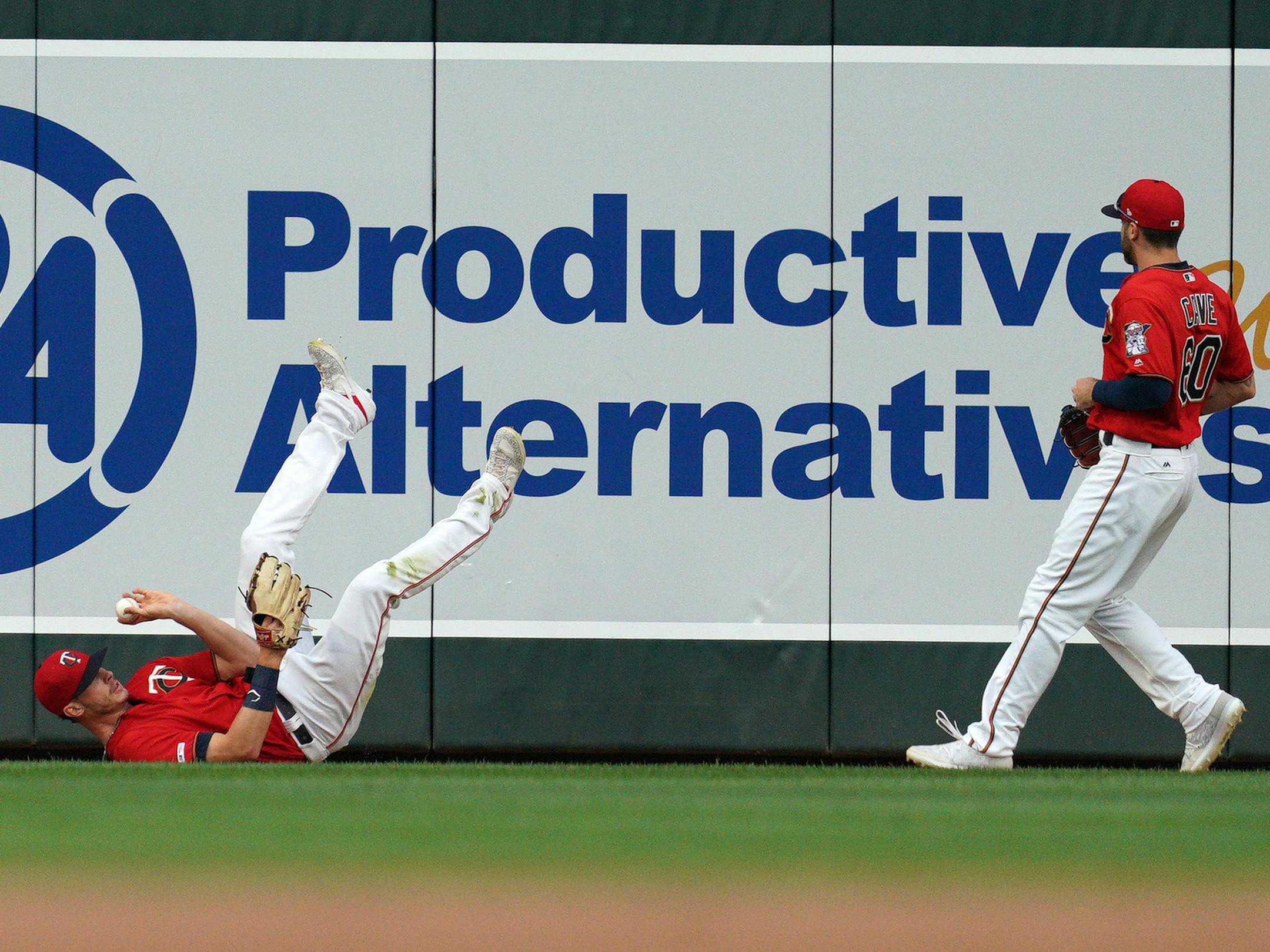 Minnesota Twins center fielder Max Kepler (26) threw the ball up to Minnesota Twins right fielder Jake Cave (60) after he hit the wall snagging a ball hit by Cleveland Indians center fielder Oscar Mercado (35) for the out in the first inning. ] ANTHONY SOUFFLE &#x2022; anthony.souffle@startribune.com The Minnesota Twins played the Cleveland Indians in an MLB game Friday, Aug. 9, 2019 at Target Field in Minneapolis.