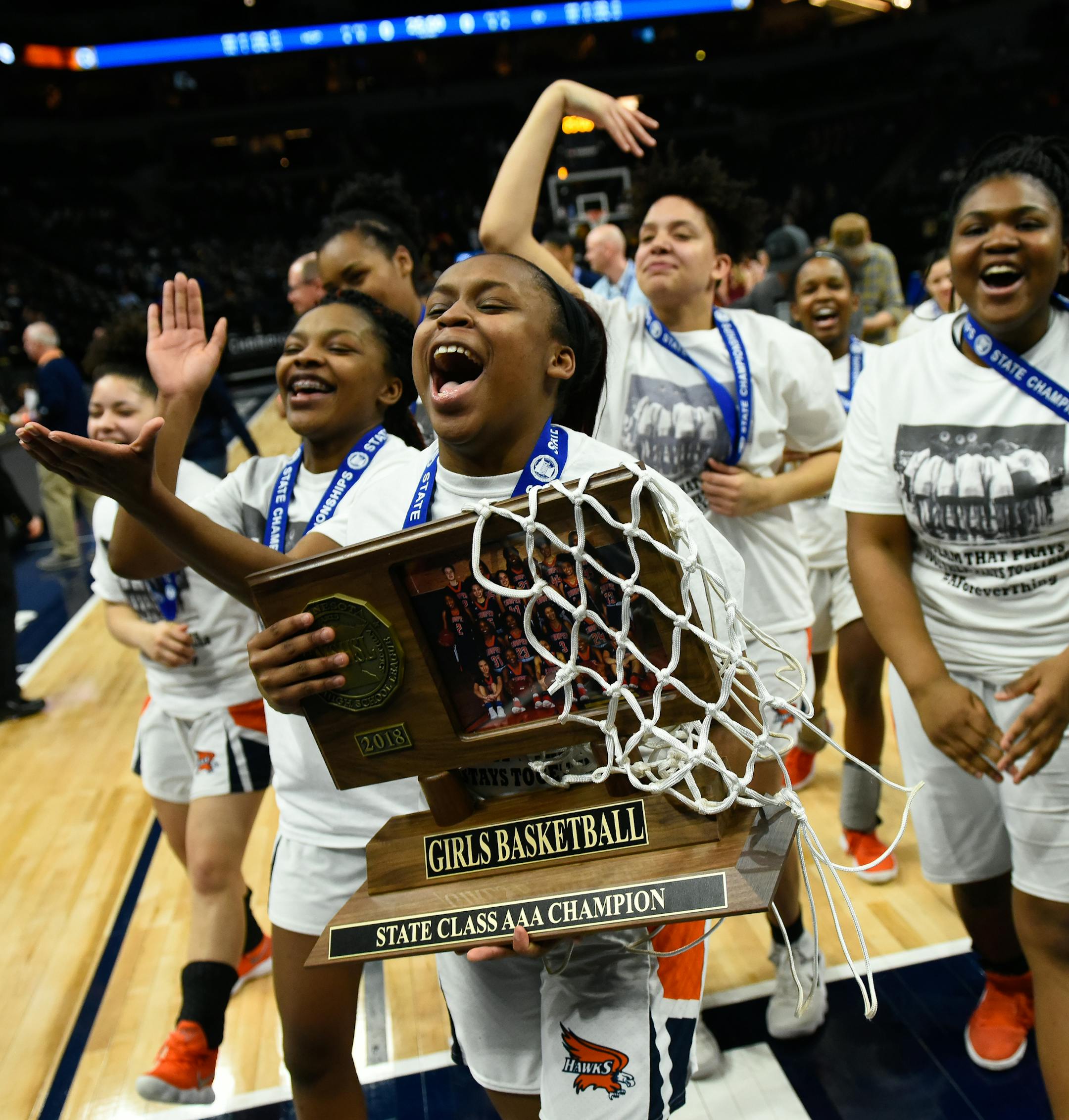 Robbinsdale Cooper players, including guard Ty'neecia Longs (4), holding trophy, celebrated their team's 49-37 victory over Northfield to win the Class 3A championship title Saturday. ] AARON LAVINSKY ï aaron.lavinsky@startribune.com Robbinsdale Cooper played Northfield in the girlsí basketball Class 3A state championship game on Saturday, March 17, 2018 at Target Center in Minneapolis, Min