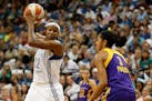 Lynx forward Rebekkah Brunson (32) protected the ball against the defense of Sparks center Candace Parker during Game 3 of the Western Conference semi