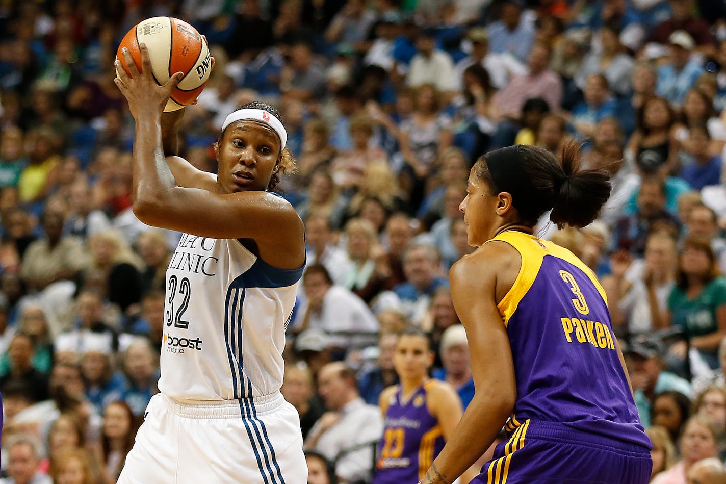 Lynx forward Rebekkah Brunson (32) protected the ball against the defense of Sparks center Candace Parker during Game 3 of the Western Conference semifinals last September.