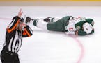 Wild forward Eric Fehr laid on the ice after being checked into the boards by Canadiens left winger Kenny Agostino during the first period Monday.