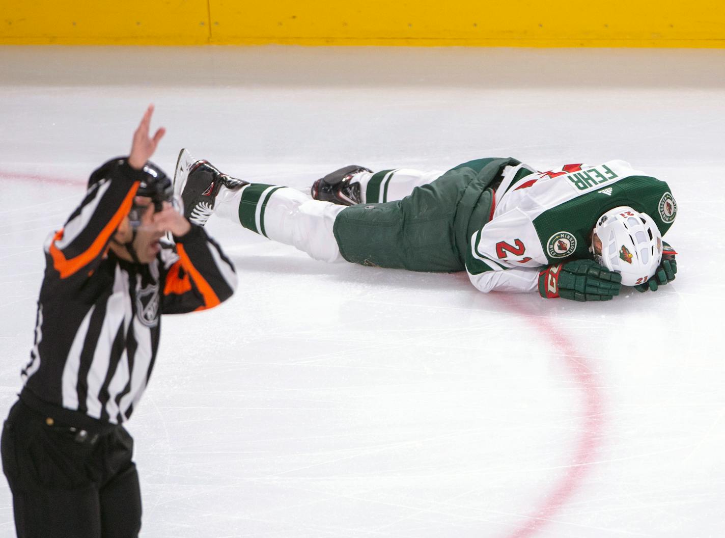 Wild forward Eric Fehr laid on the ice after being checked into the boards by Canadiens left winger Kenny Agostino during the first period Monday.