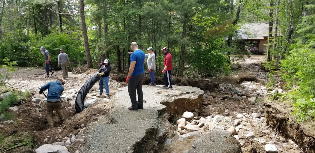Campers helped Camp du Nord maintenance staff repair washed-out roads and trails on June 19.
