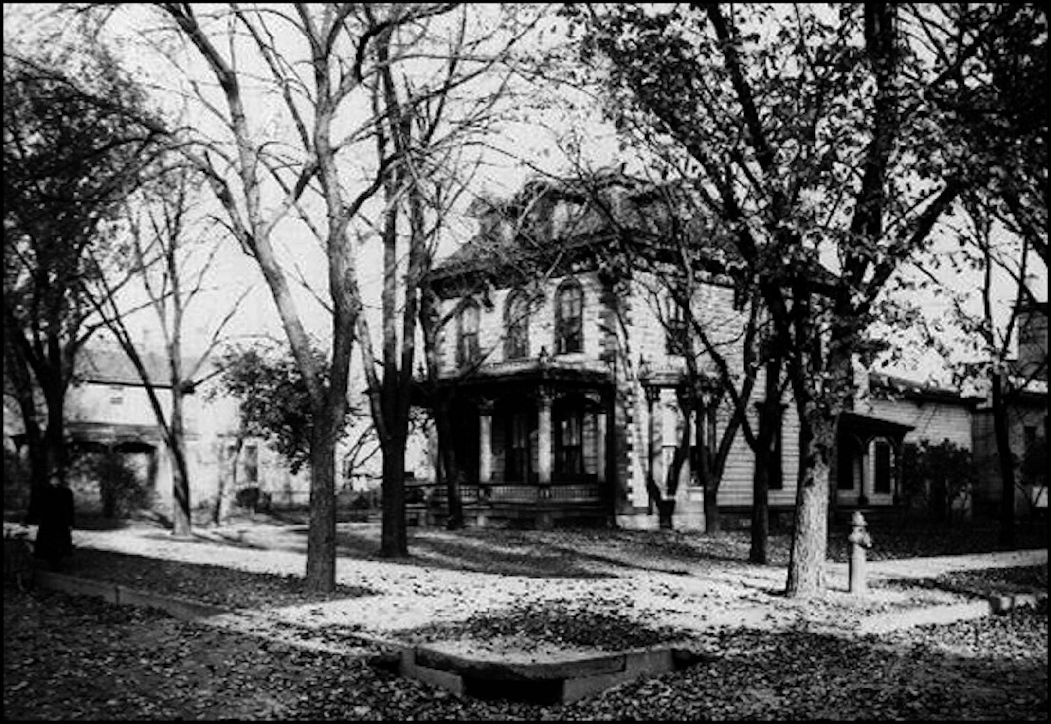 MRS BROWN'S BOARDING HOUSE AT 9TH STREET AND 6TH AVENUE SOUTH in Minneapolis
Note young woman at left with a bicycle. There are lots of fallen leaves in the street.