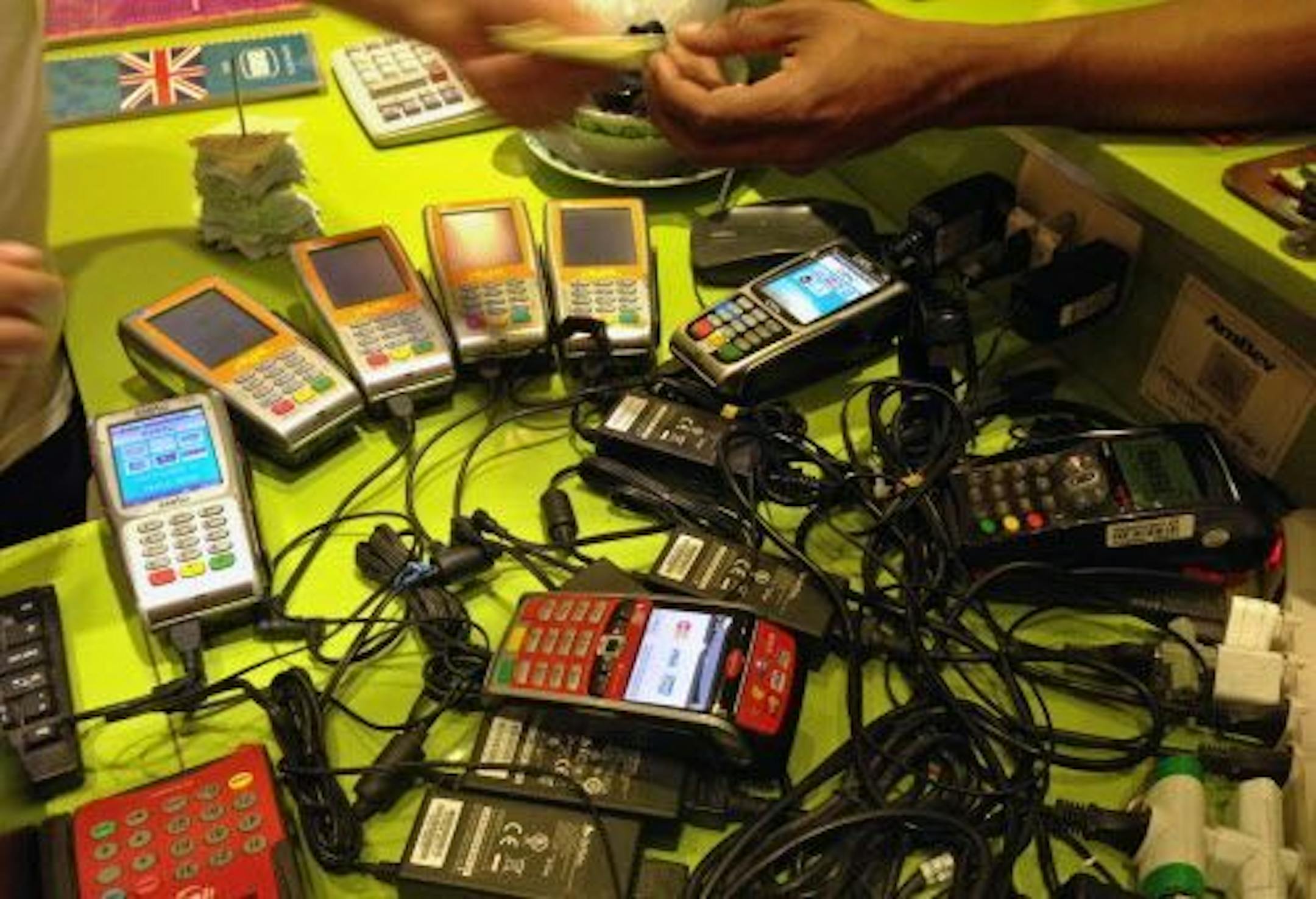 In this June 20, 2014 photo, machines used to process credit cards sit on counter in a restaurant at a shopping mall in Rio de Janeiro, Brazil.