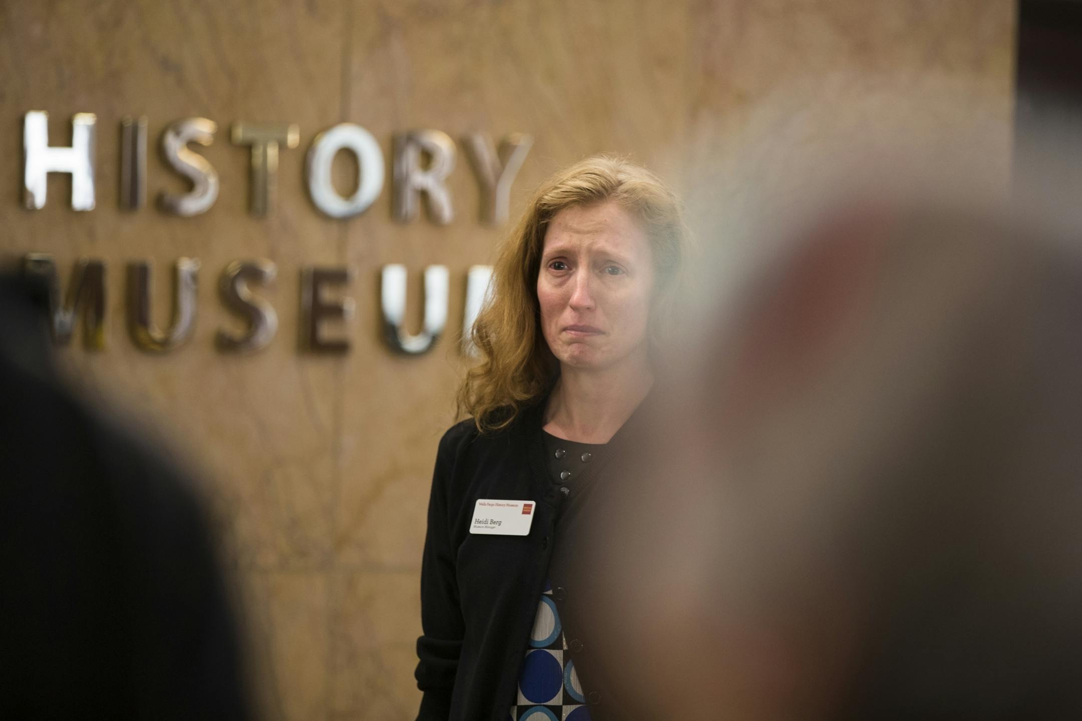 Heidi Berg, a manager at the Wells Fargo History Museum, gets emotional as she watches the a "Freeman Friday" pass through the Wells Fargo Building.