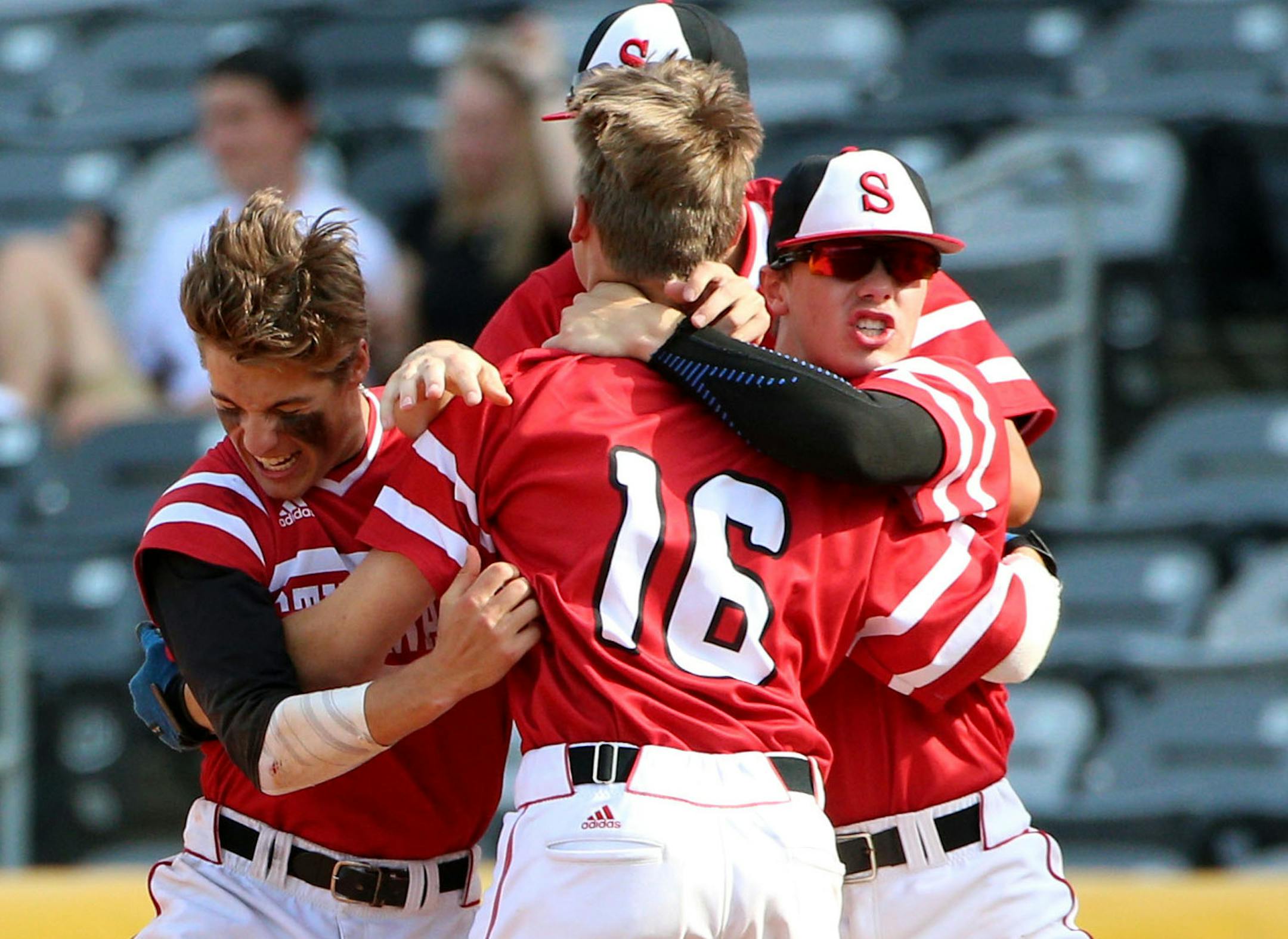 The Stillwater baseball team embraces pinch hitter Benjamin Borrman (16) after he hit the game-winning base hit against Mounds View on Thursday. ] ALEX KORMANN • alex.kormann@startribune.com The Stillwater high school baseball team defeated Mounds View 3-2 with a game winning single in the bottom of the 7th inning of the AAAA quarter-finals on Thursday June 14, 2018.
