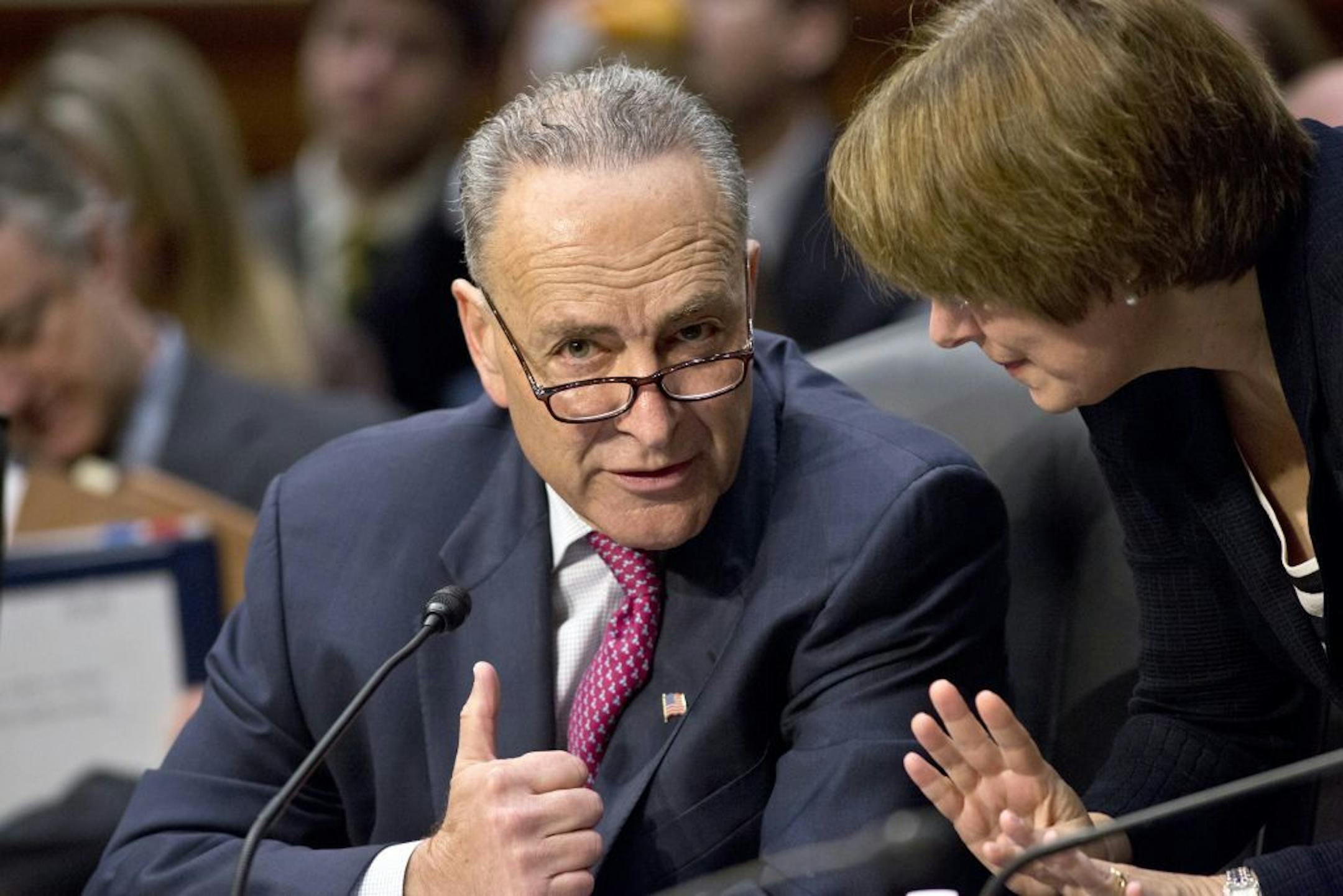 Sen. Chuck Schumer, D-N.Y., left, confers with Sen. Amy Klobuchar, D-Minn., as the Senate Judiciary Committee meets on immigration reform on Capitol Hill in Washington, Thursday, May 9, 2013. A bill to enact dramatic changes to the nation's immigration system and put some 11 million immigrants here illegally on a path to citizenship is facing its first congressional test as the Senate Judiciary Committee begins considering proposed changes to the 844-page legislation.
