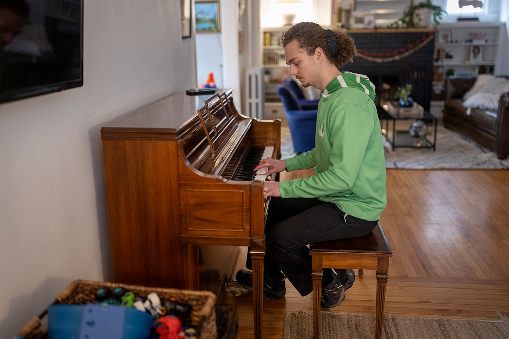 Pianocycle’s Drew Stamps tested the keys on a piano that he delivered to Ona Balck in Minneapolis on Feb. 23.