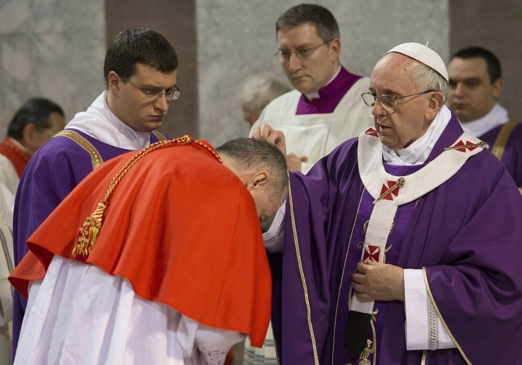 In this picture provided by the Vatican newspaper L'Osservatore Romano, Pope Francis sprinkles with ashes a Cardinal during the Ash Wednesday mass at the Santa Sabina Basilica in Rome, Wednesday, March 5, 2014. Ash Wednesday marks the beginning of Lent, a solemn period of 40 days of prayer and self-denial leading up to Easter. (AP Photo/L'Osservatore Romano, ho)