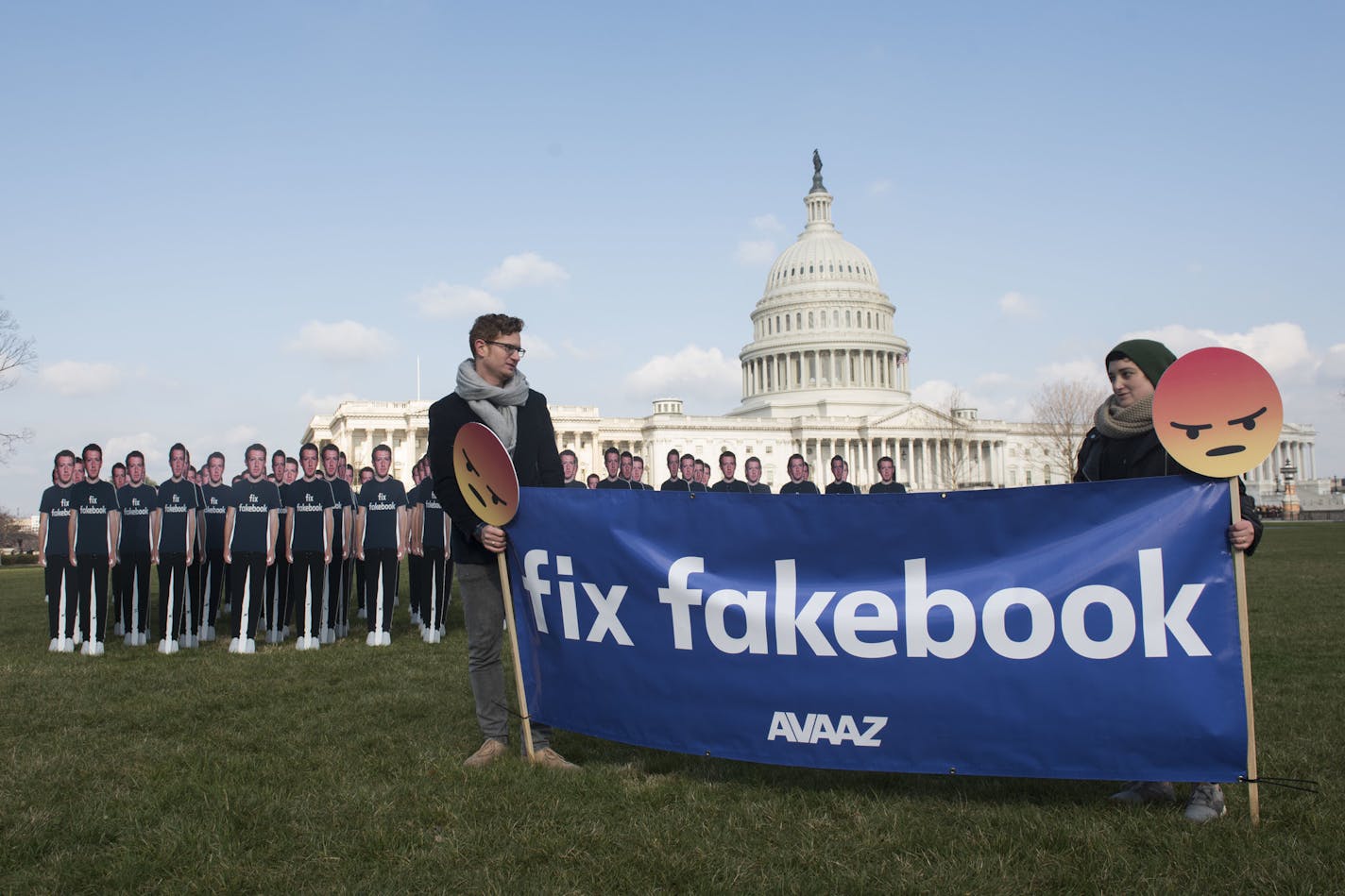 IMAGE DISTRIBUTED FOR AVAAZ - Avaaz campaigners hold a banner in front of 100 cardboard cutouts of the Facebook founder and CEO stand outside the U.S. Capitol, before Mark Zuckerberg testifies before the Senate, in Washington on Tuesday, April 10, 2018. Advocacy group Avaaz is calling attention to hundreds of millions of fake accounts still spreading disinformation on Facebook, and calling for the social media giant to submit to an independent audit. (Kevin Wolf/AP images for AVAAZ)