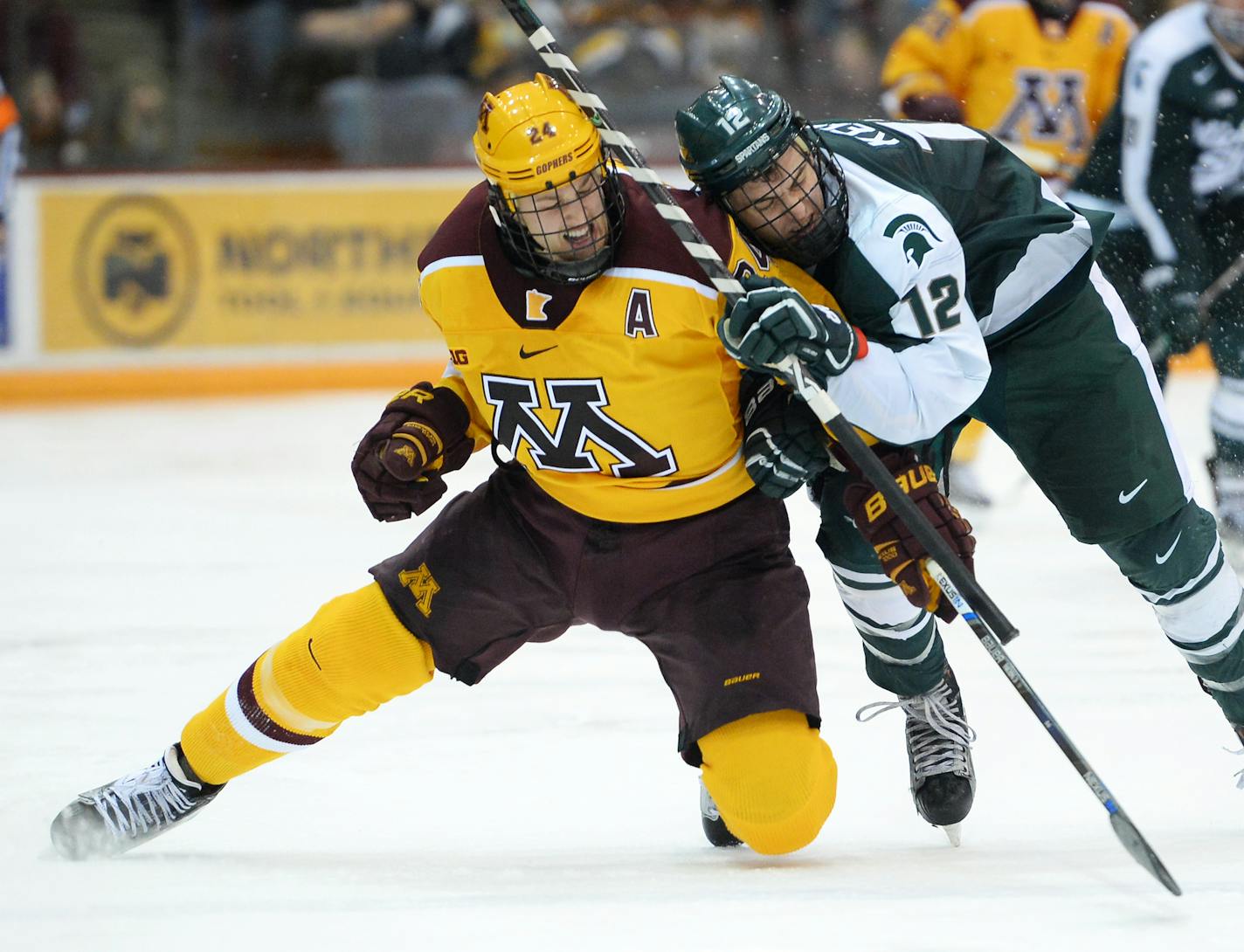 Minnesota Golden Gophers right wing Hudson Fasching (24) and Michigan State Spartans forward Ryan Keller (12) collided while chasing down the puck in the third period. ] (AARON LAVINSKY/STAR TRIBUNE) aaron.lavinsky@startribune.com The University of Minnesota Golden Gophers mens' hockey team played the Michigan State University Spartans on Saturday, Jan. 16, 2016 at Mariucci Arena in Minneapolis, Minn.