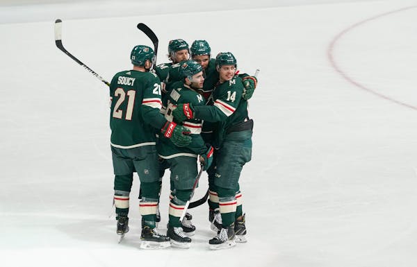 Minnesota Wild Luke Kunin (19) is in the center of congratulations for Minnesota's sixth and final goal of the game beating Edmonton 6-5. ] GLEN STUBB