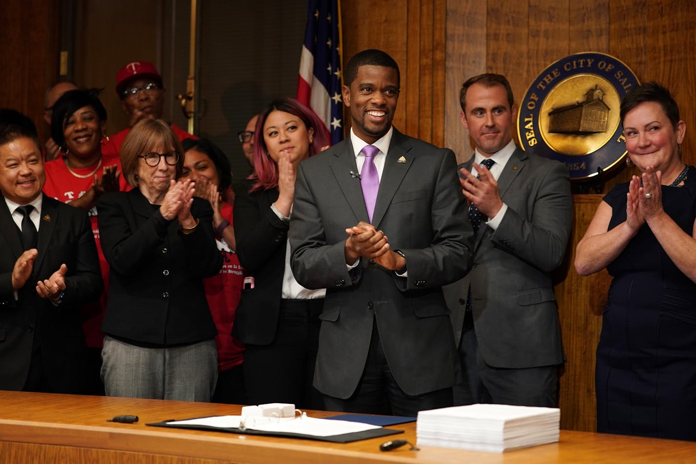 St. Paul Mayor Melvin Carter smiled as he acknowledged his wife and parents during an official signing ceremony of the $15 minimum wage ordinance.