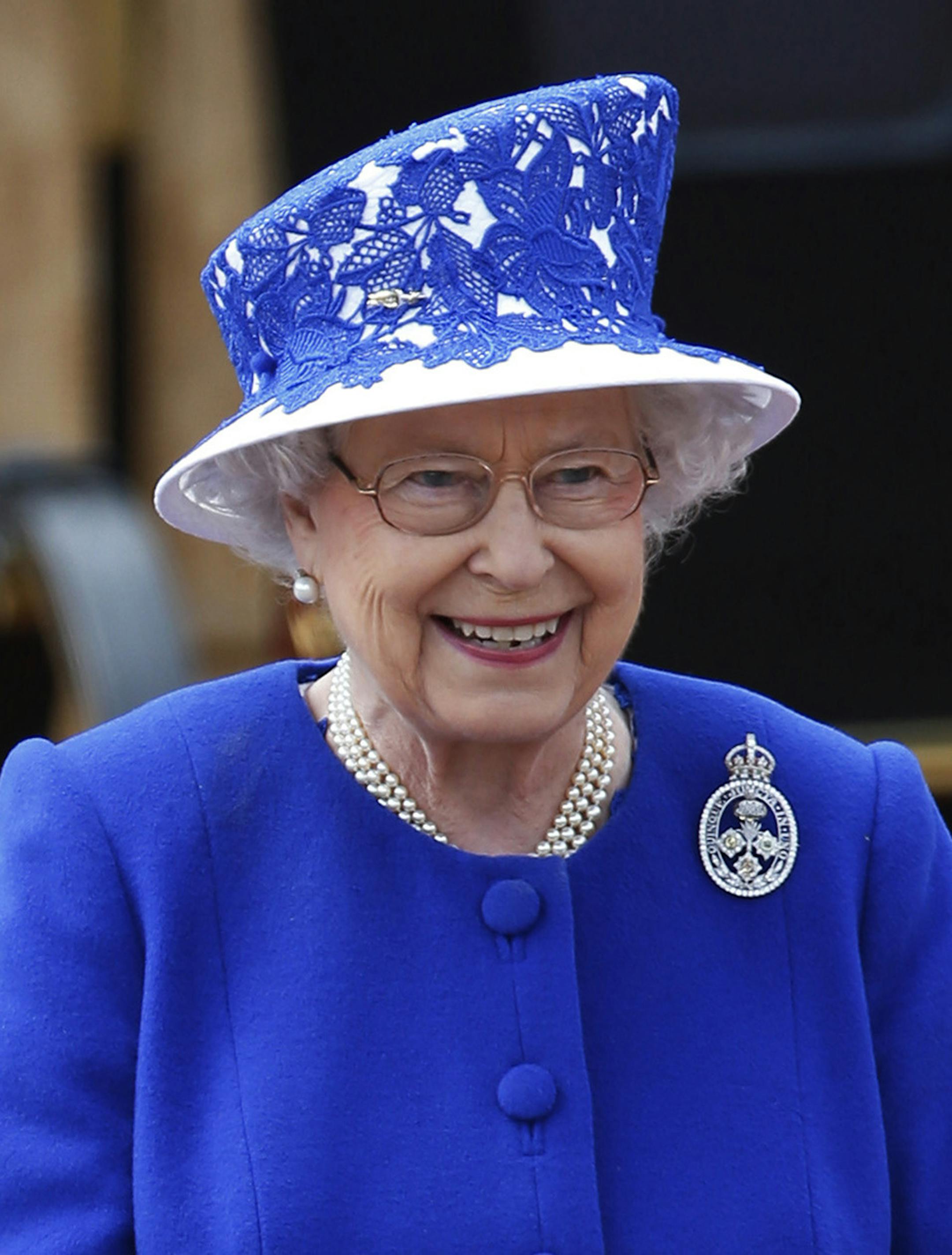 Britain's Queen Elizabeth II as the Guards march pass outside Buckingham Palace after the Trooping The Colour, at the Horse Guards Parade in London, Saturday, June 15, 2013. Queen Elizabeth II is celebrating her birthday with traditional pomp and circumstance _ but without her husband by her side. More than 1,000 soldiers, horses and musicians are taking part in the parade known as ‚ÄúTrooping the Color,‚Äù an annual ceremony. (AP Photo/Sang Tan) ORG XMIT: MIN20