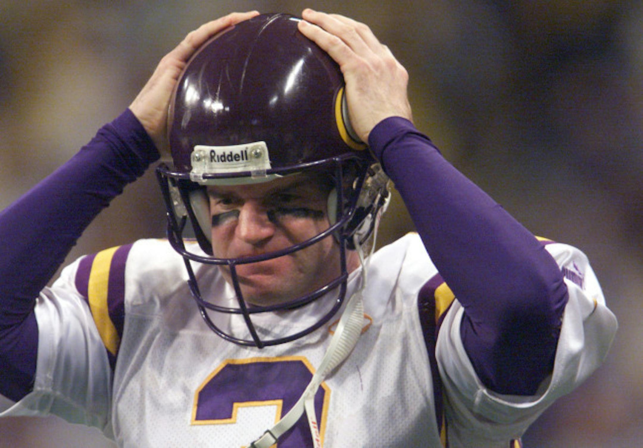 St. Louis, MO 1/18/2000 - The Vikings lose to the St. Louis Rams at the Trans World Dome in St. Louis, MO., score 49-37. -- A frustrated Jeff George replaces his helmet to go back onto the field during the final minutes of the fourth quarter during the playoff loss to the St. Louis Rams.
