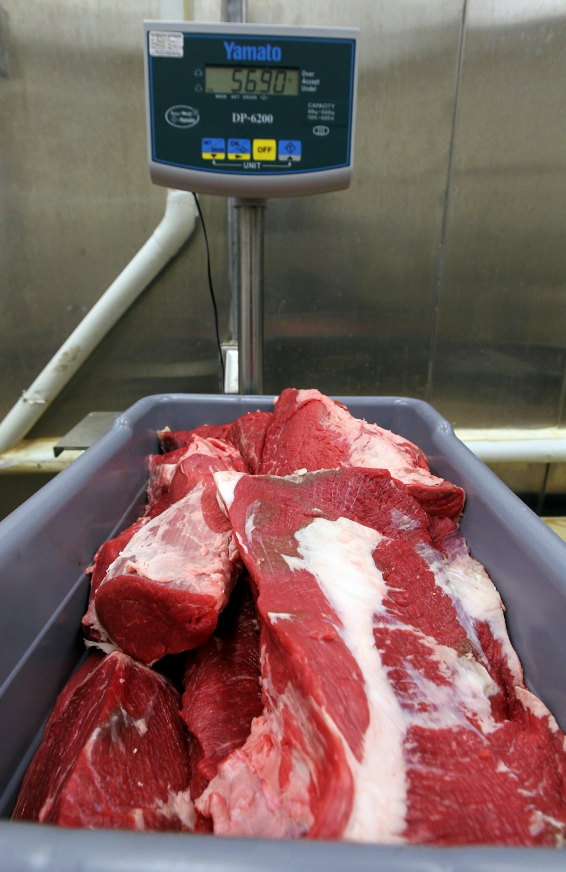 Fresh cuts of meat are weighed in the cutting room prior to packaging and sale in the Andrew Boss Laboratory of Meat Science at the University of Minnesota