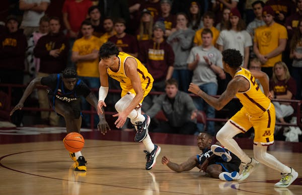 Dawson Garcia (3) beat DePaul Blue Demons forward Yor Anei (10) to the ball on Monday. But the Gophers shot poorly from the field in losing to the Blu