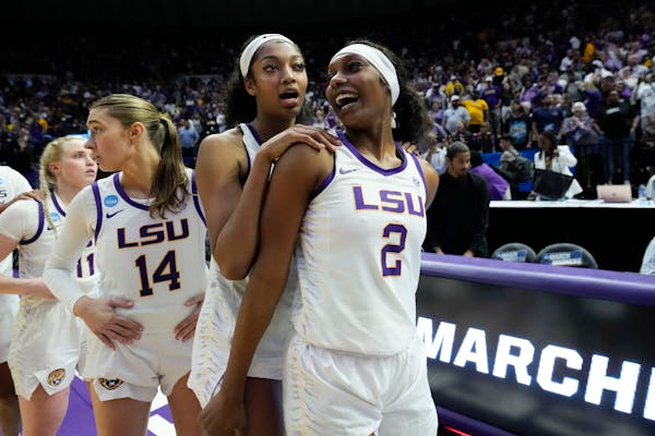 LSU forward Angel Reese and forward Amani Bartlett (2) celebrate after their won an early-round game in the NCAA tournament last month.