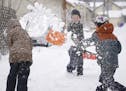 Alma prepared for a shovel full of snow from Sean. Alma Connoy, 7, her brother Graham Connoy, 8 and their neighbor and friend Sean Barker, 8, spent th