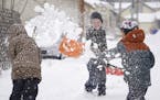 Alma prepared for a shovel full of snow from Sean. Alma Connoy, 7, her brother Graham Connoy, 8 and their neighbor and friend Sean Barker, 8, spent th