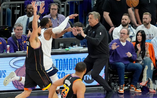 Timberwolves guard Mike Conley ran into coach Chris Finch on this play near the end of Game 4 in Phoenix on Sunday. Finch's knee injury will require s