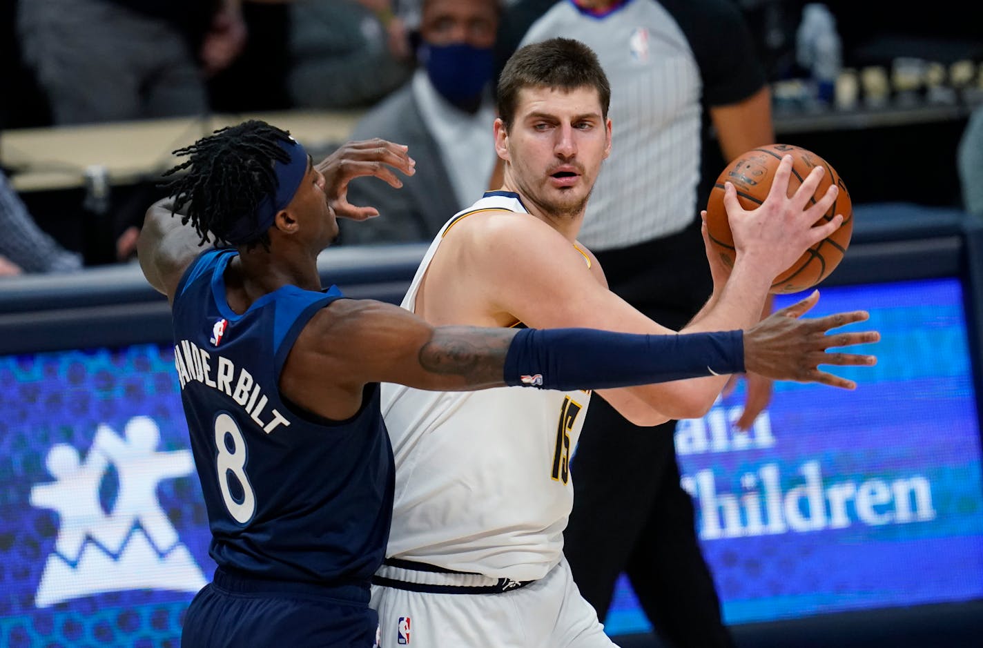 Nuggets center Nikola Jokic looked to pass as Timberwolves forward Jarred Vanderbilt defended him Tuesday. Jokic didn't have to pass often, collecting 35 points, 15 rebounds and six assists in Denver's 123-116 victory.