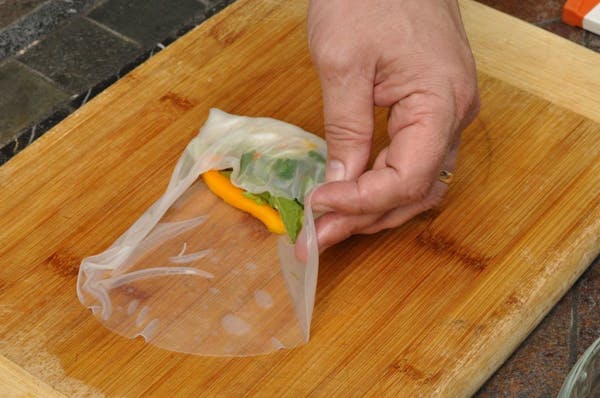 When making summer rolls, practice makes perfect: Rice noodles, vegetables and mango are wrapped in rice paper.