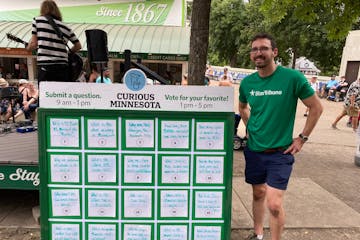 Eric Roper, right, stood next to the board of questions at the State Fair on September 2, 2023.