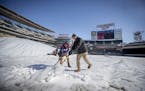 Target Field grounds crew worked to remove ice and snow from the field and concourse in preparation for the home opener.