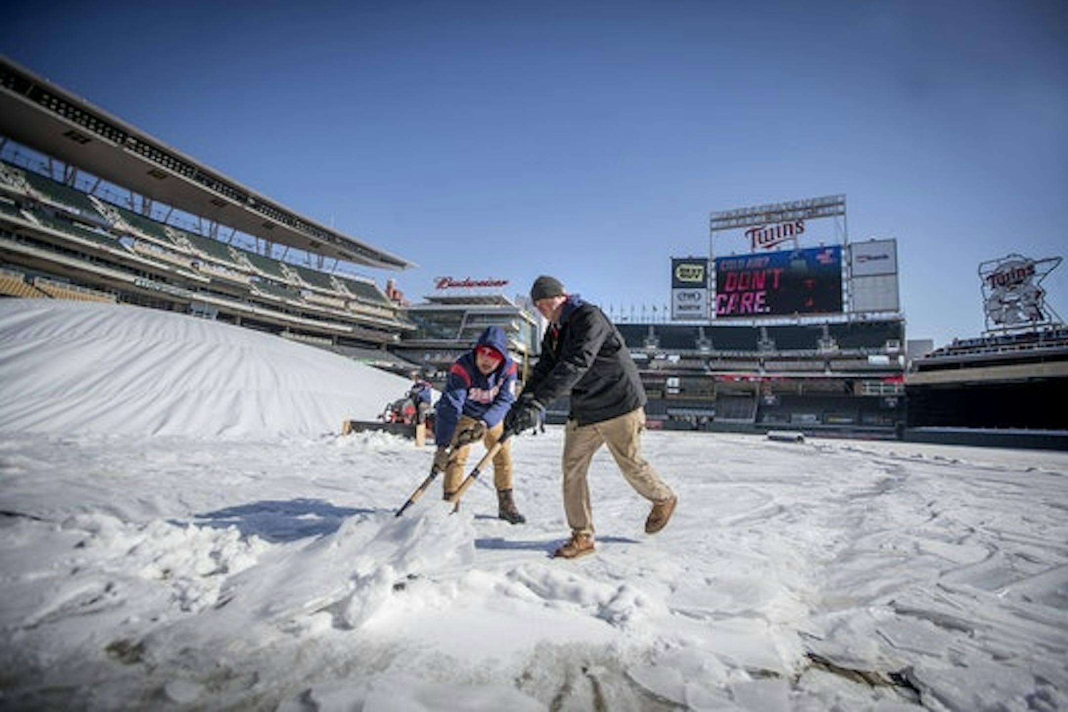 Target Field grounds crew worked to remove ice and snow from the field and concourse in preparation for the home opener.