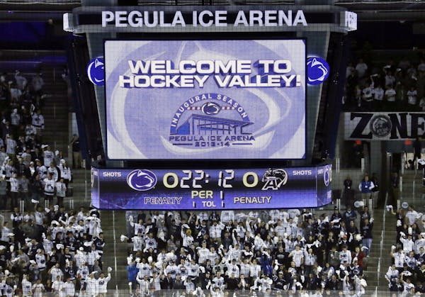 The Penn State student section cheers as during pre-game festivities before the face off of Penn State against Army in the first NCAA college hockey g