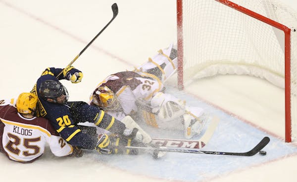 Adam Wilcox (32) can't stop a shot by Merrimack College's Hampus Gustafsson (20) during first period action of the Mariucci Classic Friday, Jan. 2, 20
