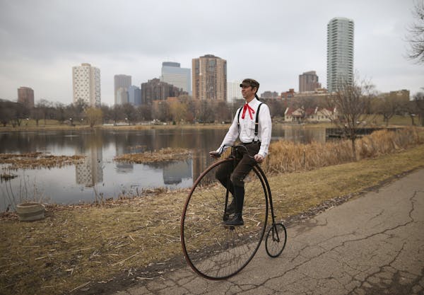 Bicycle enthusiast Juston Anderson rides an 1890 Victor high wheeler bicycle in Loring Park.